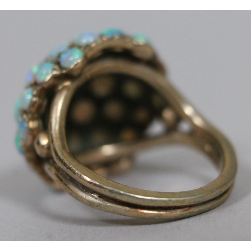 173 - An opal cabochon cluster ring, hallmarked 9ct gold band and setting, gross wt. 6.9g.