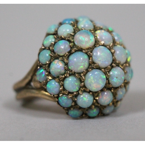 173 - An opal cabochon cluster ring, hallmarked 9ct gold band and setting, gross wt. 6.9g.