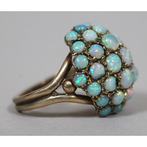 173 - An opal cabochon cluster ring, hallmarked 9ct gold band and setting, gross wt. 6.9g.