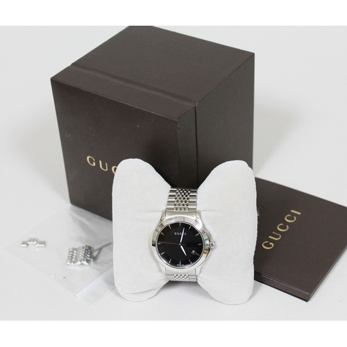 178 - A Gucci G Timeless stainless steel wristwatch, black dial with baton markers, luminous hands and dat... 