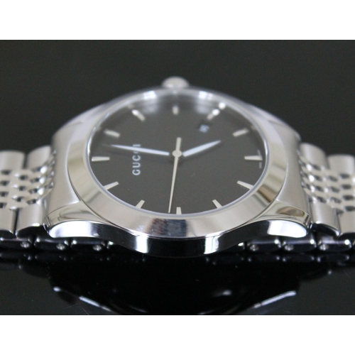 178 - A Gucci G Timeless stainless steel wristwatch, black dial with baton markers, luminous hands and dat... 