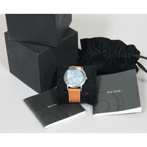 180 - A Paul Smith stainless steel wristwatch with tan leather strap, having quartz movement, aqua blue di... 