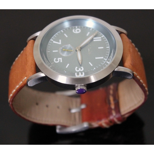 180 - A Paul Smith stainless steel wristwatch with tan leather strap, having quartz movement, aqua blue di... 