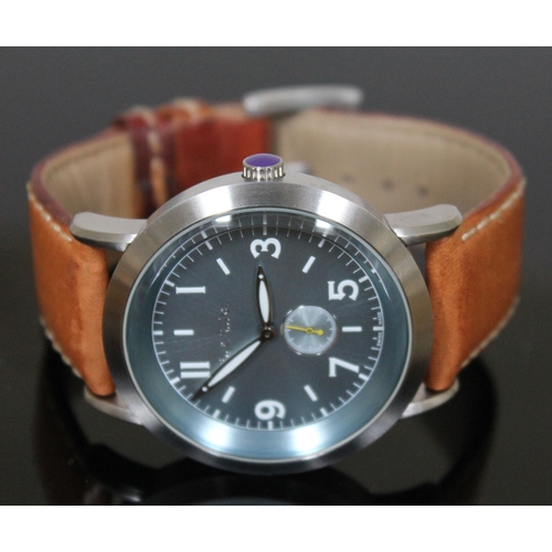 180 - A Paul Smith stainless steel wristwatch with tan leather strap, having quartz movement, aqua blue di... 