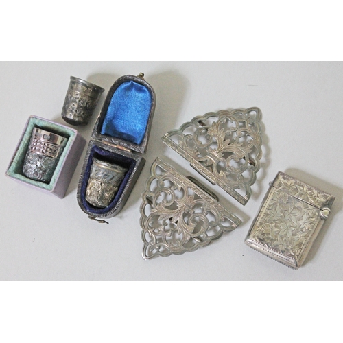 196 - Hallmarked silver comprising a belt buckle, a vesta case and three thimbles.