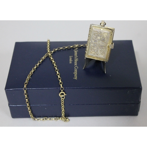 231 - A St James's House Company hallmarked silver gilt pendant watch in the form of a book, with silver g... 