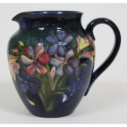 306 - A Moorcroft pottery Spring Flower jug, height 15cm.