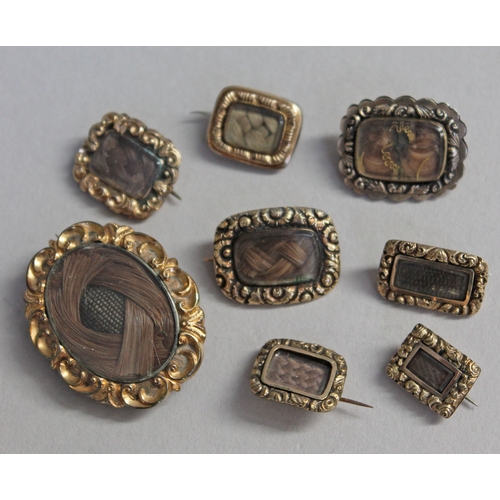 241 - A group of eight William IV/early Victorian yellow metal mourning brooches each having central plait... 