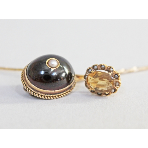 243 - A Victorian yellow metal garnet cabochon and pearl stick pin and another set with a citrine coloured... 