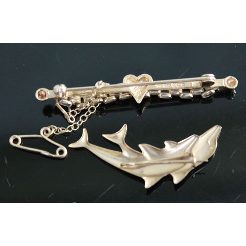 245 - Two 9ct gold brooches, one formed as leaping dolphins, wt. 4.2g.