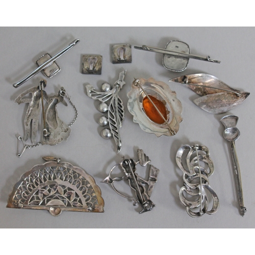 251 - A mixed lot of silver brooches and earrings including a Scottish brooch set with a citrine coloured ... 