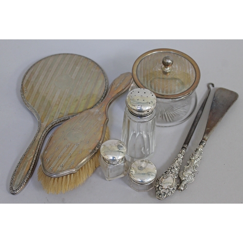 269 - A mixed lot of hallmarked silver comprising a pair of button hooks, four silver topped jars and silv... 