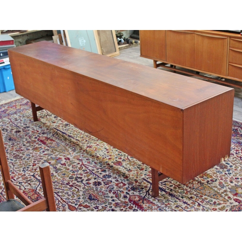 75 - A 1960s 8' teak sideboard having eight drawers either split either side of a central cabinet, length... 