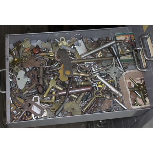 82 - A set of metal file drawers and contents comprising watch spares/repairs and tools, keys etc.