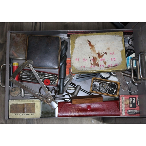 82 - A set of metal file drawers and contents comprising watch spares/repairs and tools, keys etc.