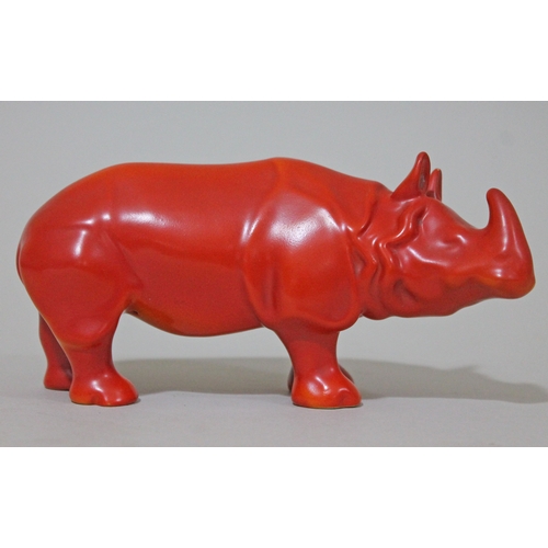 300 - A rare Royal Doulton standing rhinoceros in red/orange glaze, probably a trial piece, length 18.5cm.