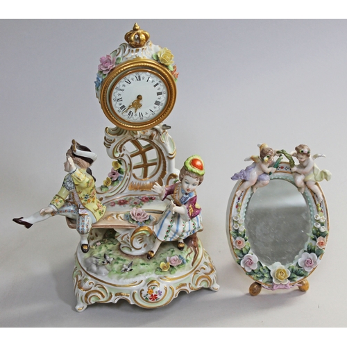 352 - A Continental porcelain figural clock inscribed Handarbeit to base, height 31cm, together with a Con... 