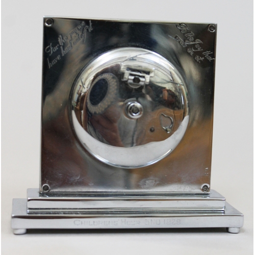 87 - An Art Deco chrome 8 day travel clock, square dial and stepped base, the reverse inscribed 'for the ... 