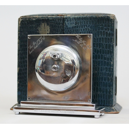 87 - An Art Deco chrome 8 day travel clock, square dial and stepped base, the reverse inscribed 'for the ... 