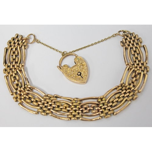 103 - A 9ct gold bracelet with heart locket clasp marked 9ct, the strap marked 9c, gross weight 19.9 grams... 