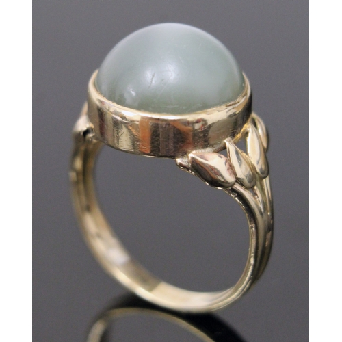 117 - A moonstone cabachon ring, the stone in bezel setting with tulip shoulders, unmarked, size N/O, gros... 