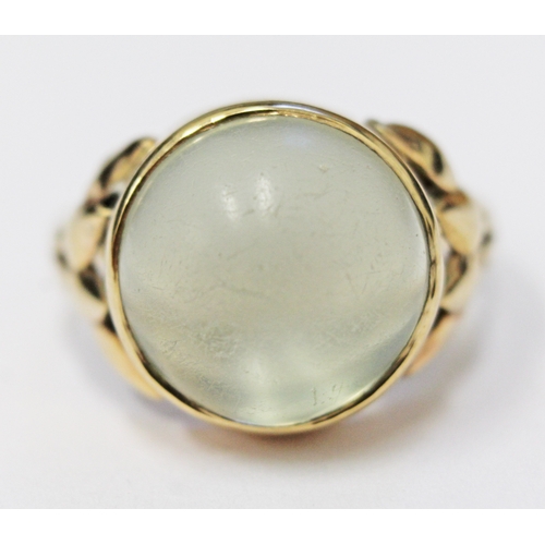 117 - A moonstone cabachon ring, the stone in bezel setting with tulip shoulders, unmarked, size N/O, gros... 