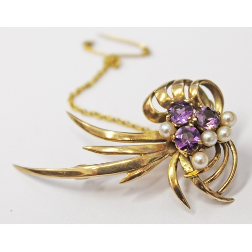 132 - A 9ct gold brooch set with amethyst coloured stones and half cut pearls, length 4cm, gross wt. 5.6g