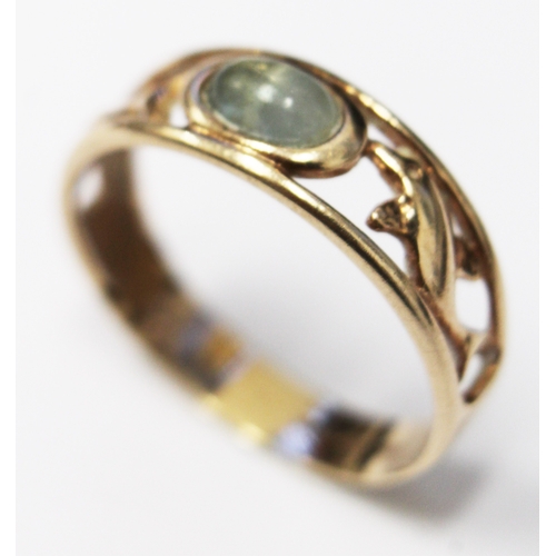 152 - A 9ct gold ring with pierced dolphin design and set with central moonstone, marked .375 with duty im... 