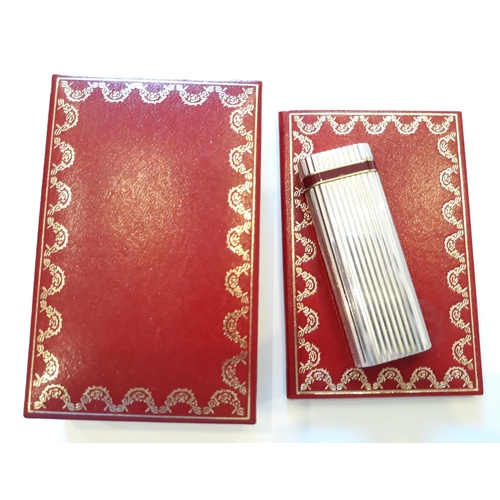 168 - A Cartier silver lighter with original red box and booklet.