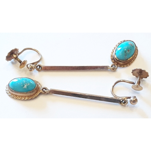 182 - A pair of 9ct gold drop earrings each set with a turquoise cabochon, marked '9ct', length 45mm, gros... 