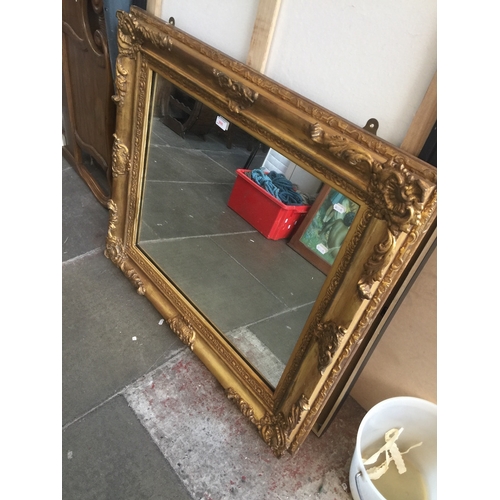 906 - A gilt and gesso ornate frame mirror