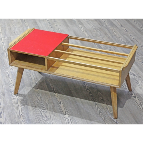 66 - A retro 1950s light oak and red coffee table, length 89cm.