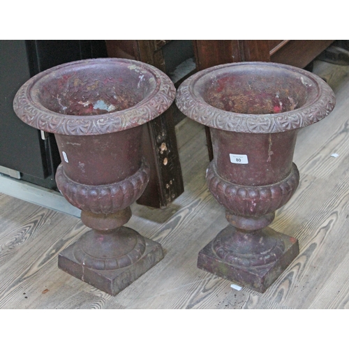 80 - A pair of cast iron garden urns, height 43cm.