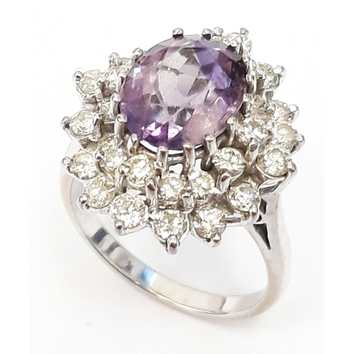 100L - A diamond and amethyst cluster ring, the central stone approx. 10mm x 8mm, white metal band unmarked... 