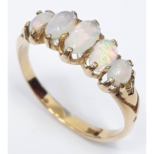 100M - A five stone opal ring, band marked '18ct', gross wt. 3g, size P.