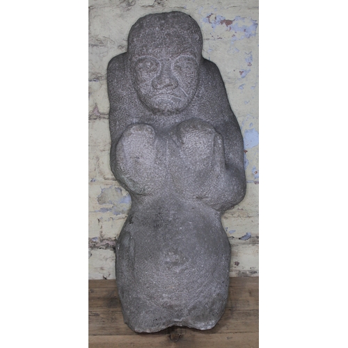 96 - A 20th Century carved stone figure depicting a fertility god, length 67cm.