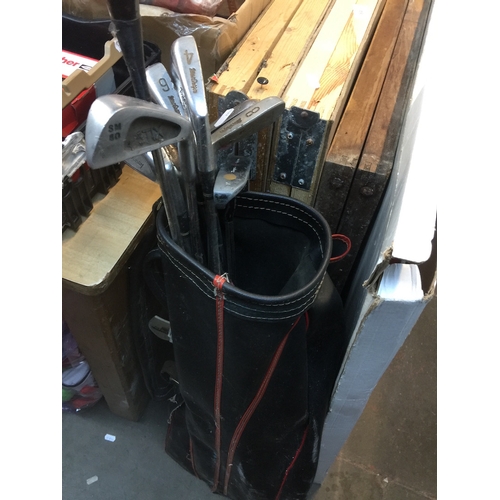 63 - A golf bag with clubs