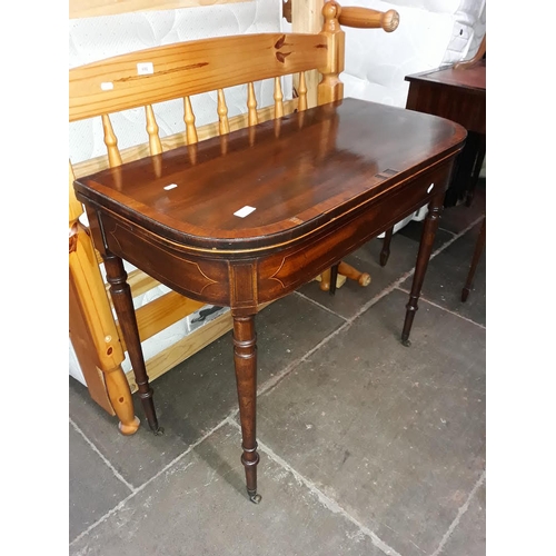 485 - A 19th century inlaid games table with turned legs and brass castors