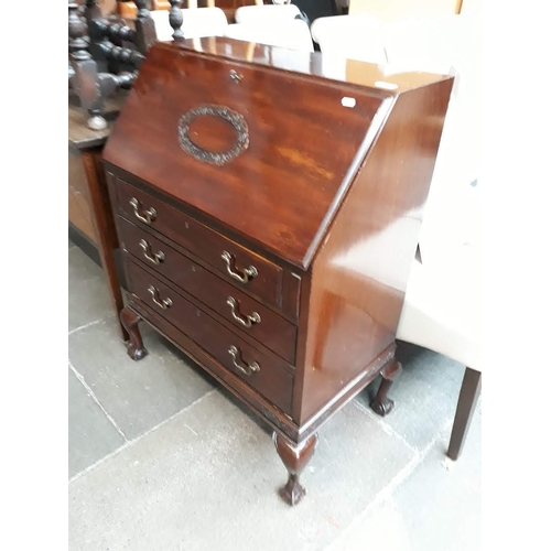 604 - A reproduction mahogany bureau on claw on ball feet