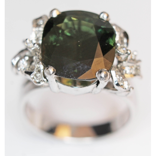 172 - A green tourmaline and diamond ring, the central stone approx. 7 carats, band marked '18K', gross we... 