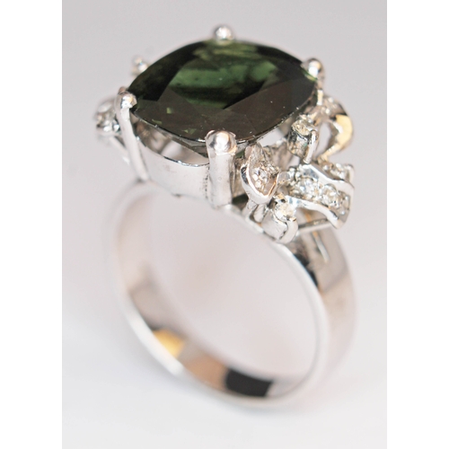 172 - A green tourmaline and diamond ring, the central stone approx. 7 carats, band marked '18K', gross we... 