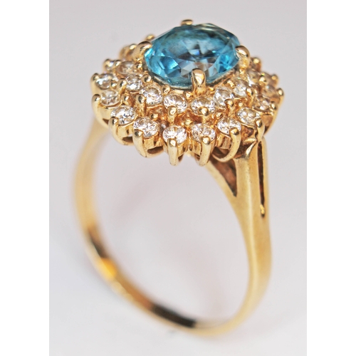 174 - A blue topaz and diamond cluster ring, the band marked '14K, gross weight 6.4g, size T.