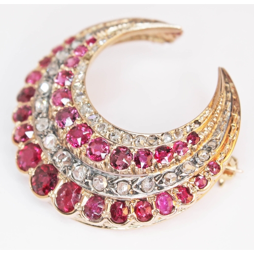 175 - A ruby and diamond crescent brooch, unmarked, gross weight 9.6g, diam. 33mm.