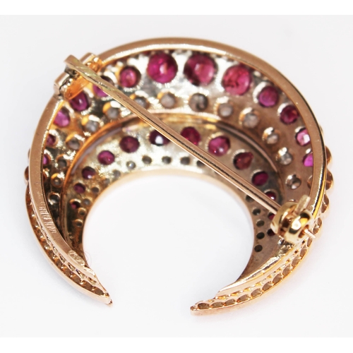 175 - A ruby and diamond crescent brooch, unmarked, gross weight 9.6g, diam. 33mm.