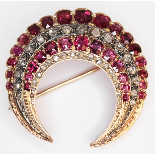 175 - A ruby and diamond crescent brooch, unmarked, gross weight 9.6g, diam. 33mm.