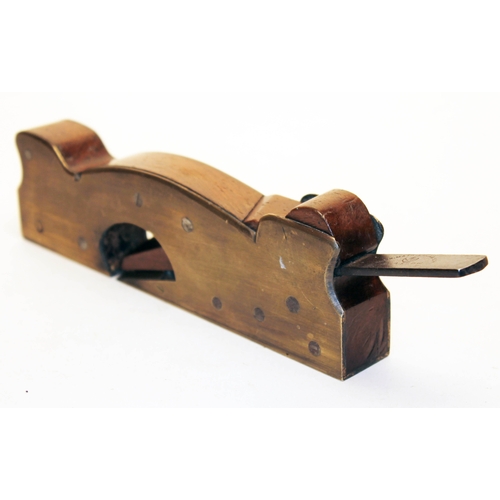 253 - A 19th century brass rebate plane of shaped form, mahogany infill and steel blade inscribed 'Alex Ma... 