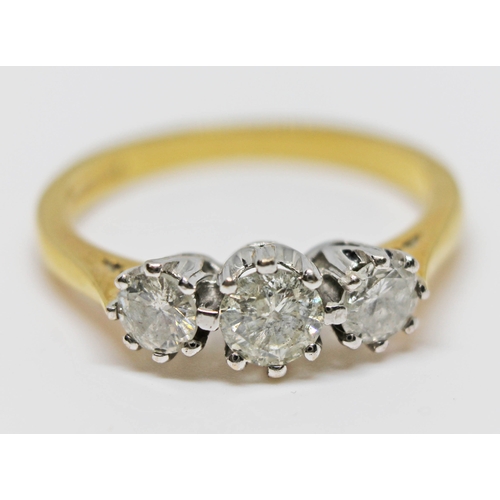 223 - A three stone diamond ring, total approx. diamond wt. 0.75 carats, hallmarked 18ct gold band, gross ... 