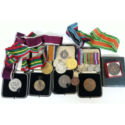 424 - A mixed lot of medals including a WWI Victory medal, sporting medals etc.