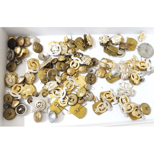 425 - A quantity of military cap badges and buttons.