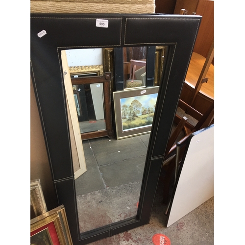 995 - A large mirror with faux leather surround